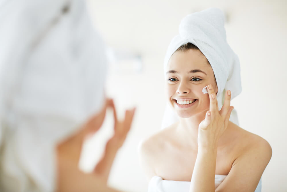 Woman applying face cream