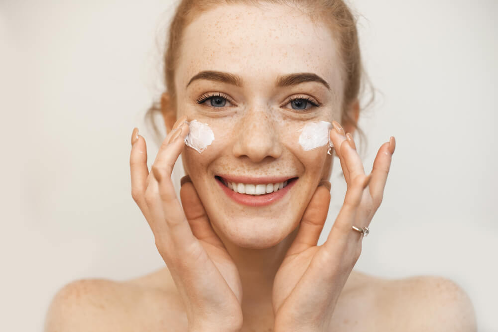 Woman applying face cream