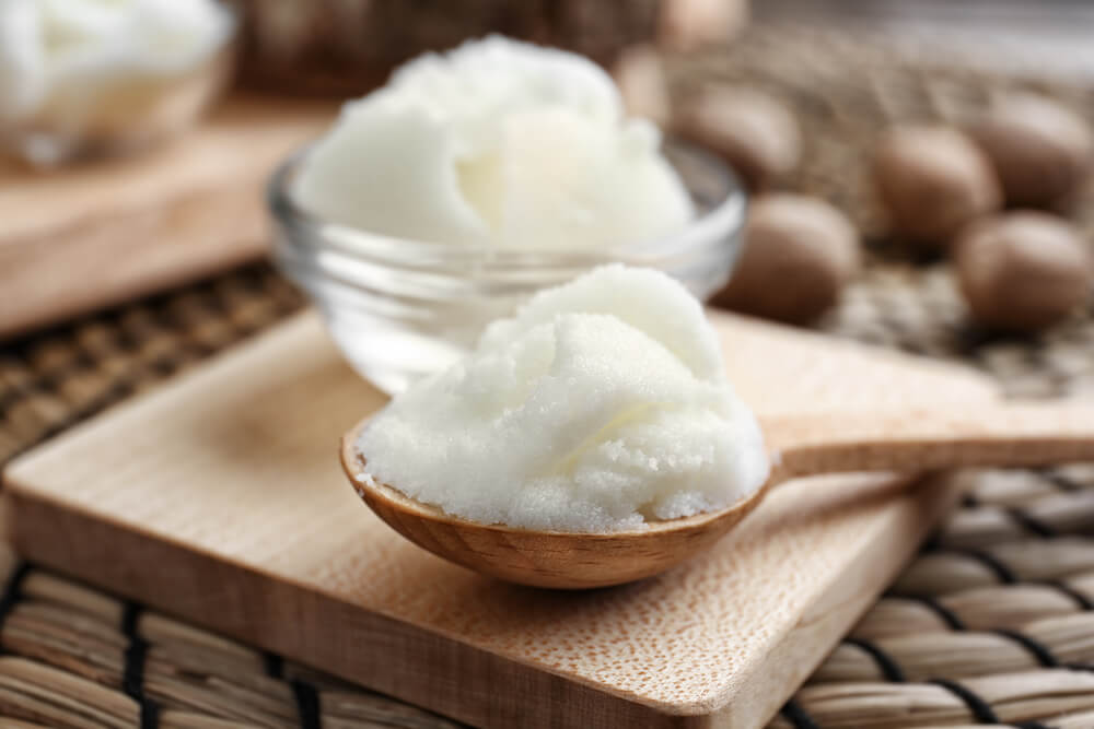 Shea butter in bowls and spoon
