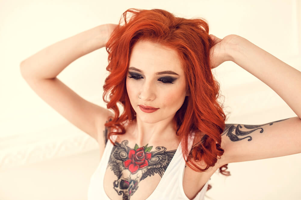 Young red-headed woman with tattoos