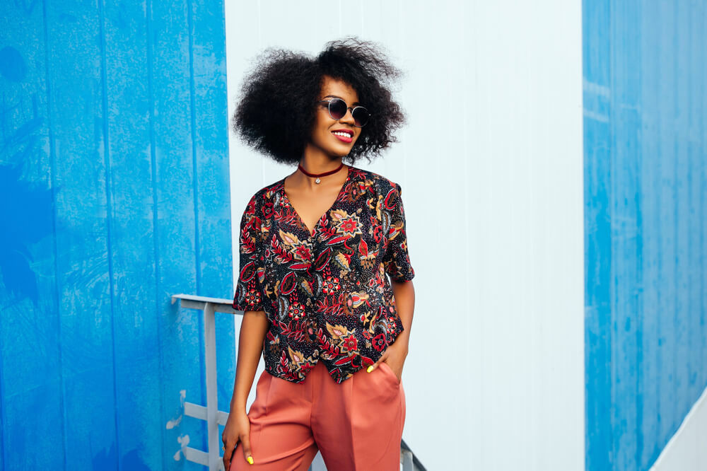 Fashionable woman in print blouse and orange-brown slacks