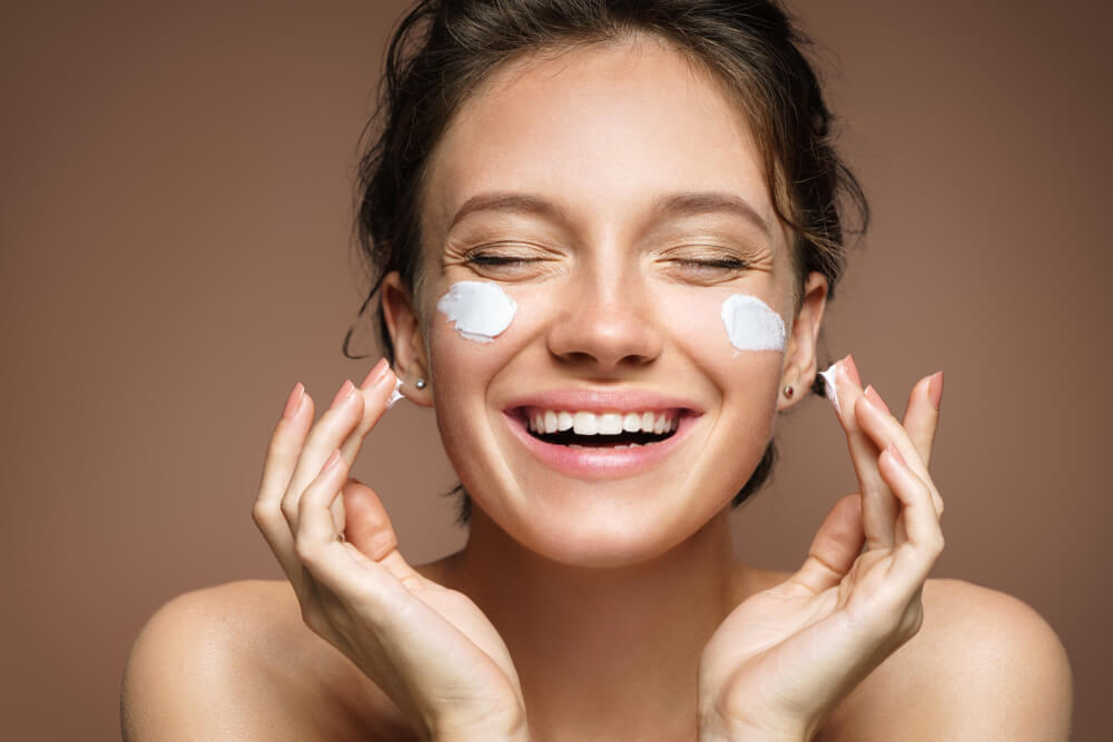 Woman applying Cabernet Collection Moisture Day cream