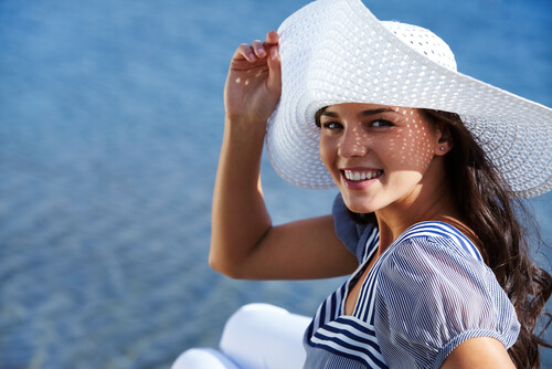 Woman covering herself with a sun hat
