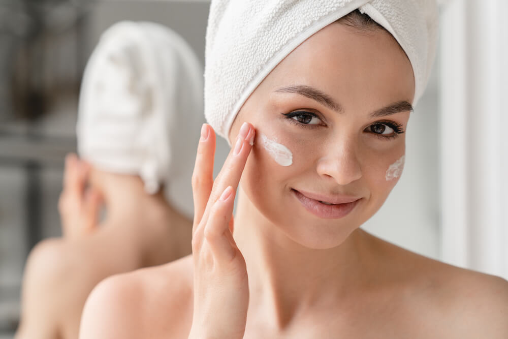 Woman applying face cream