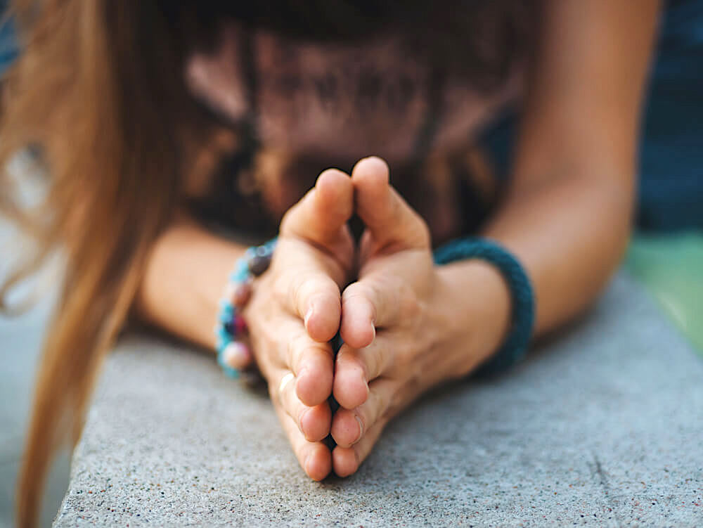 Unknown woman's hands pressed together in gratitude