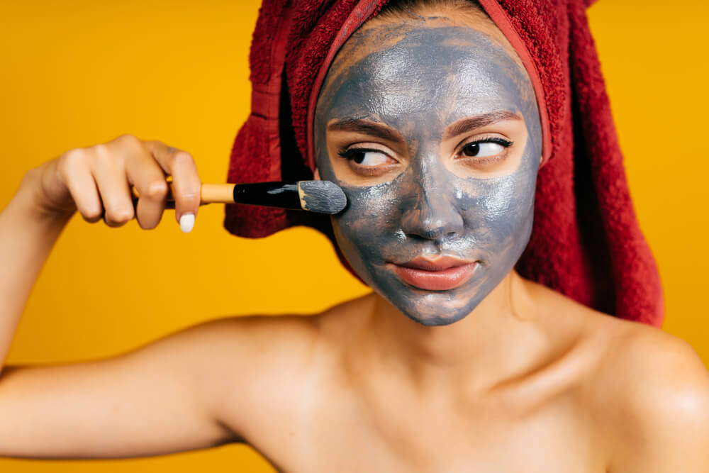 Woman applying magnetic face mask