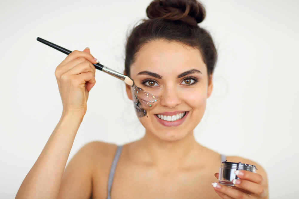 Woman applying magnetic face mask