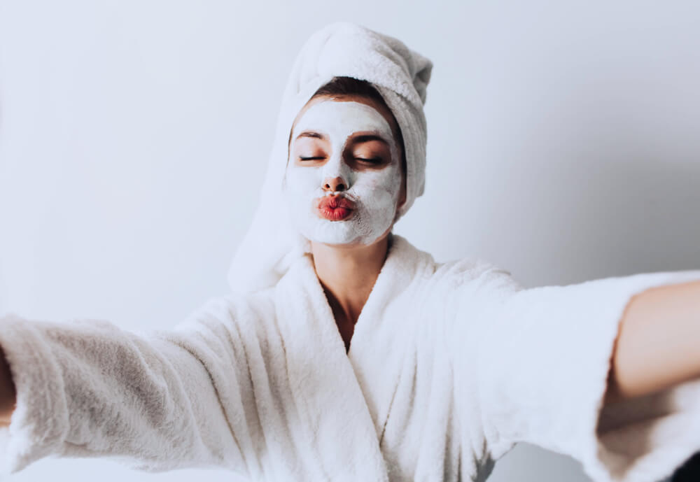 Woman with face mask taking selfie