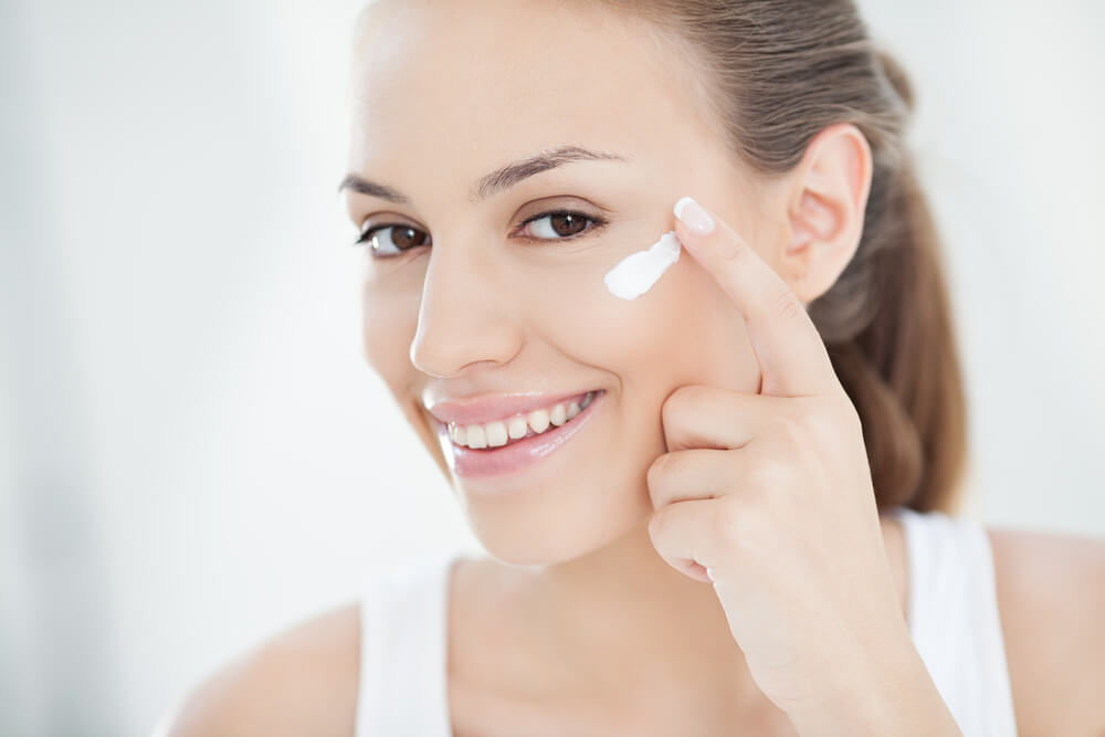 Woman applying face cream