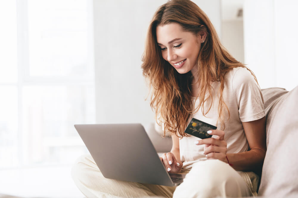 Woman with credit card and laptop