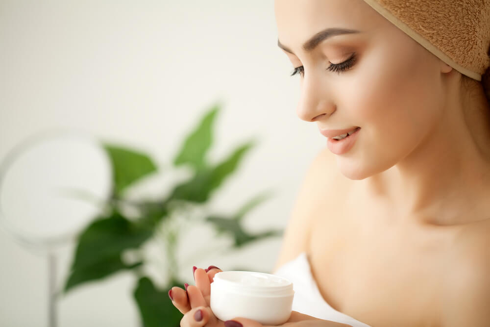 Woman looking at skincare cream