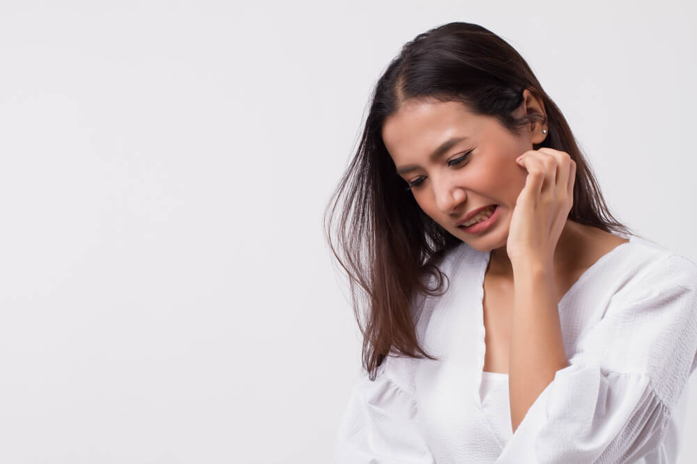 Woman scratching skin