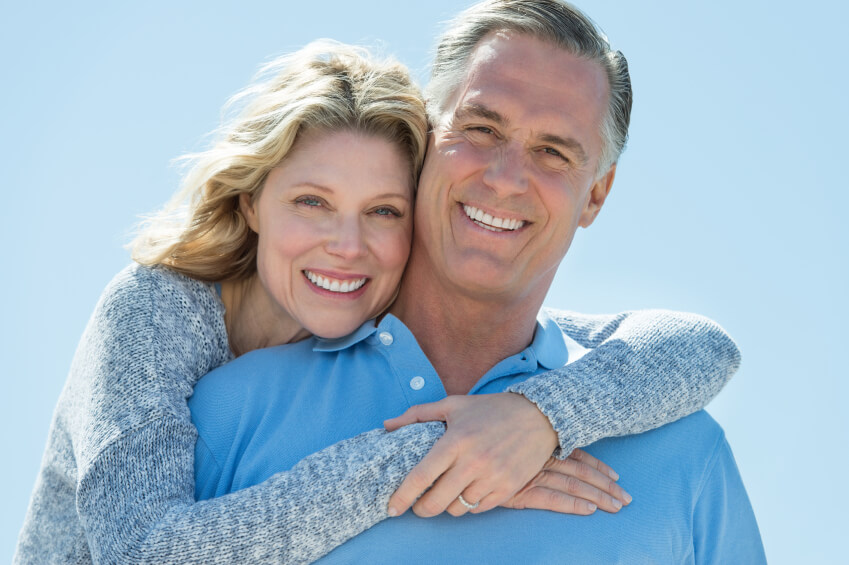 Happy senior couple smiling and holding each other