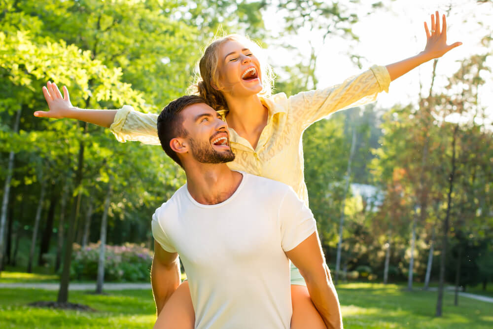Happy couple enjoying the sun outdoors