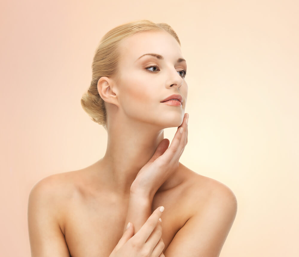 Young woman touching skin