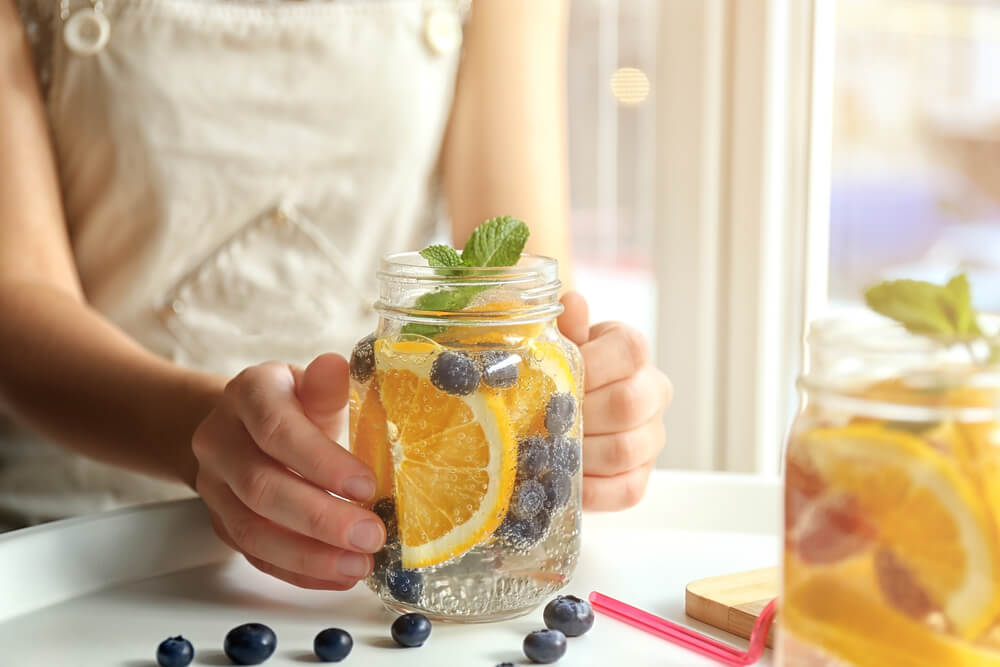 Woman drinking fruit-infused water