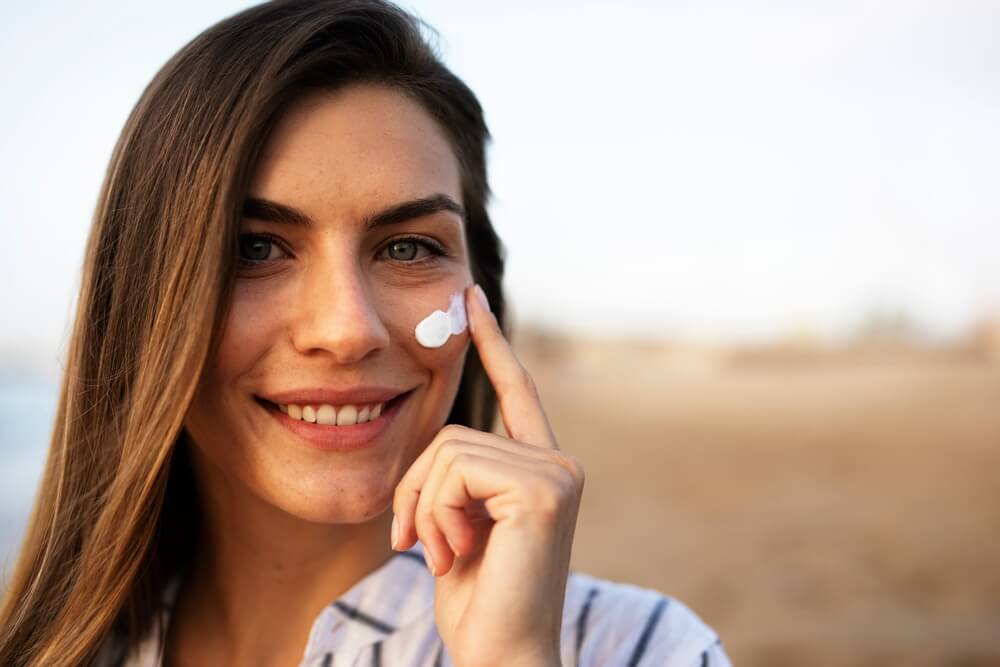 Woman applying SPF