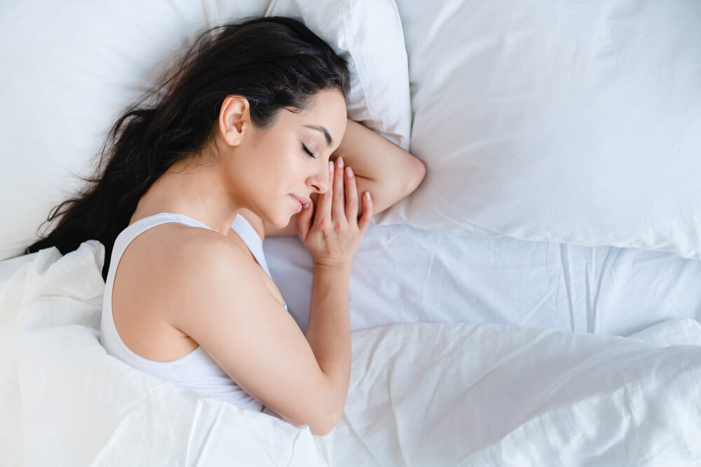 Woman sleeping - New Year’s Resolutions for Your Skin