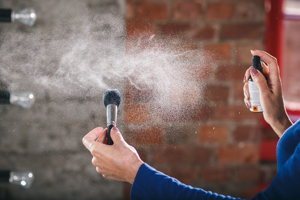 Spraying water on makeup brush