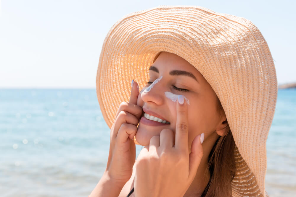 Woman applying SPF skin care for traveling