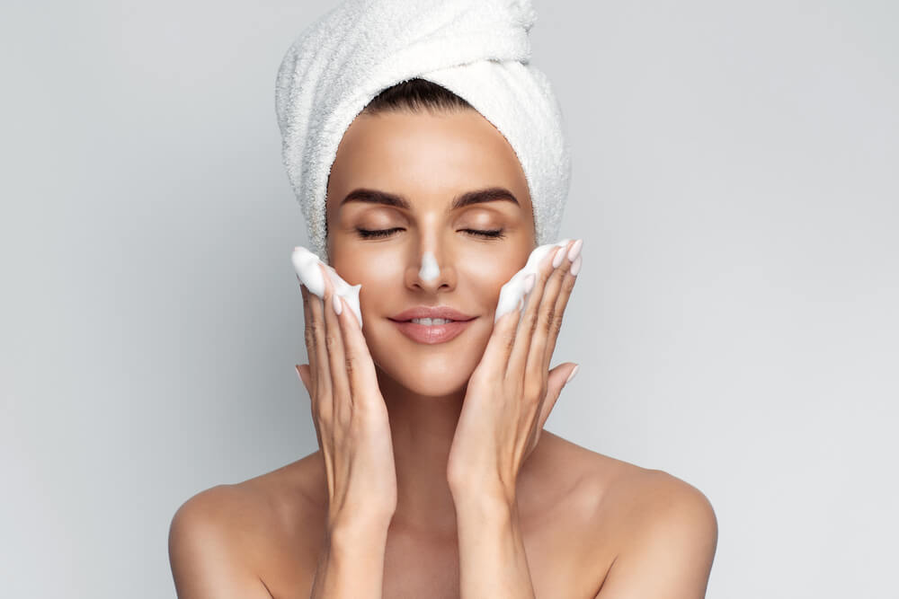 Woman cleansing skin