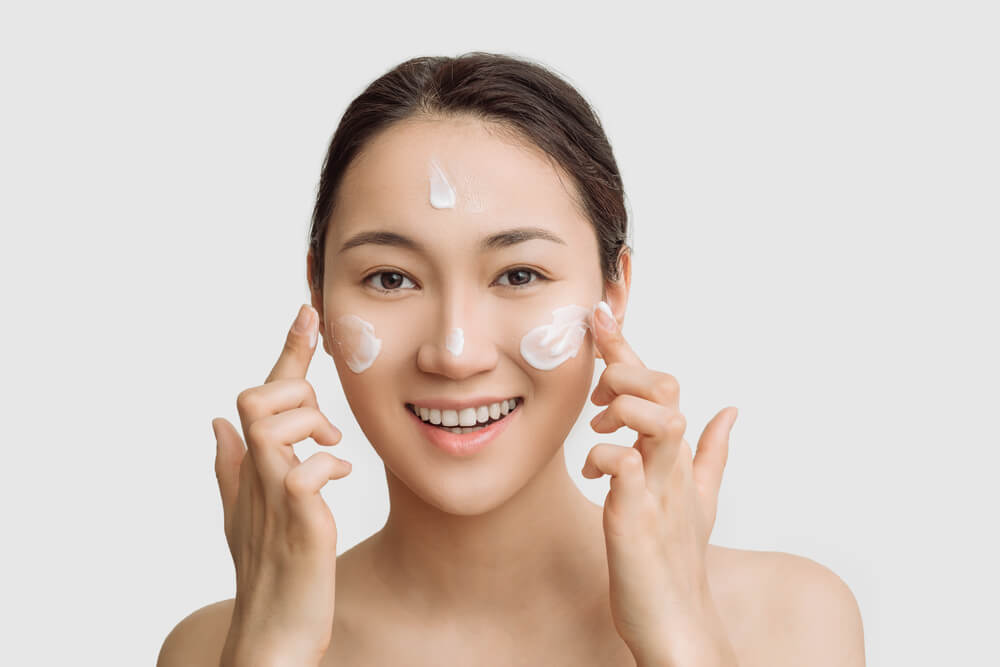 Woman applying face cream