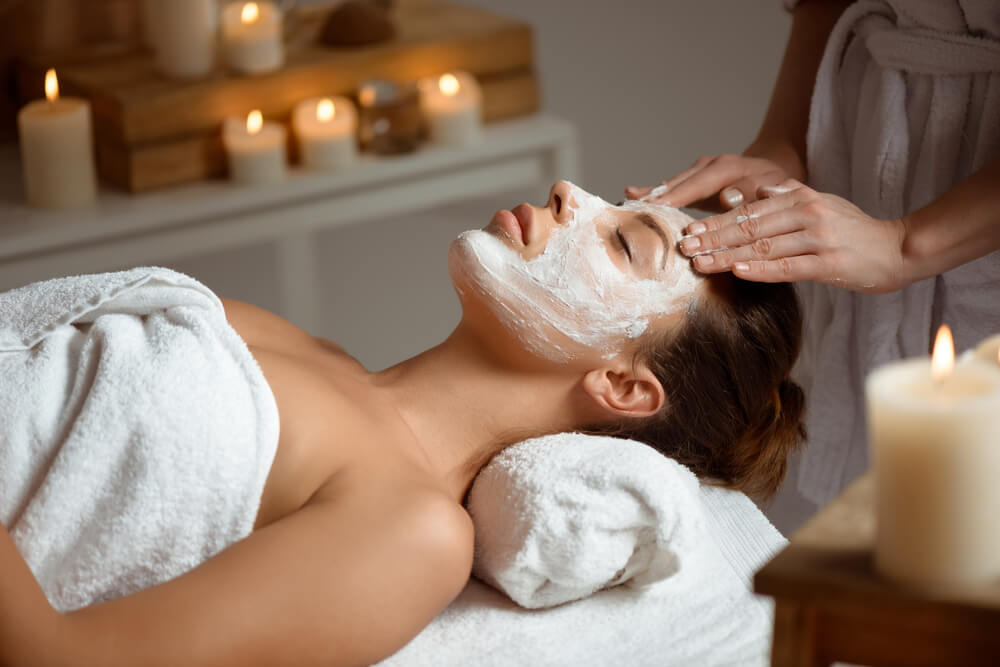 Woman enjoying facial treatment at the spa