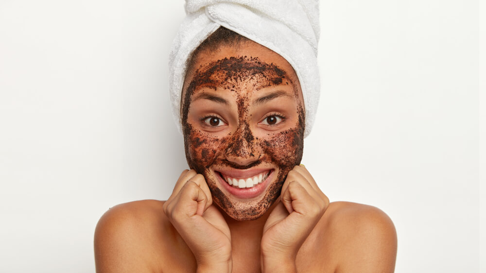 Woman exfoliating face