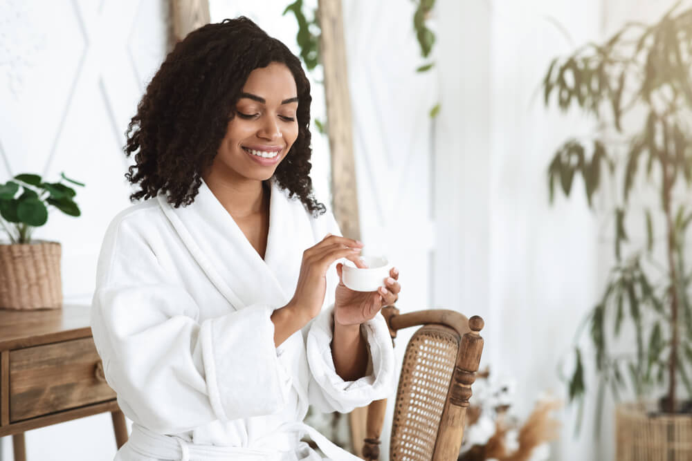 Woman using moisturizer