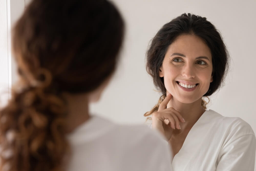 woman looking in mirror