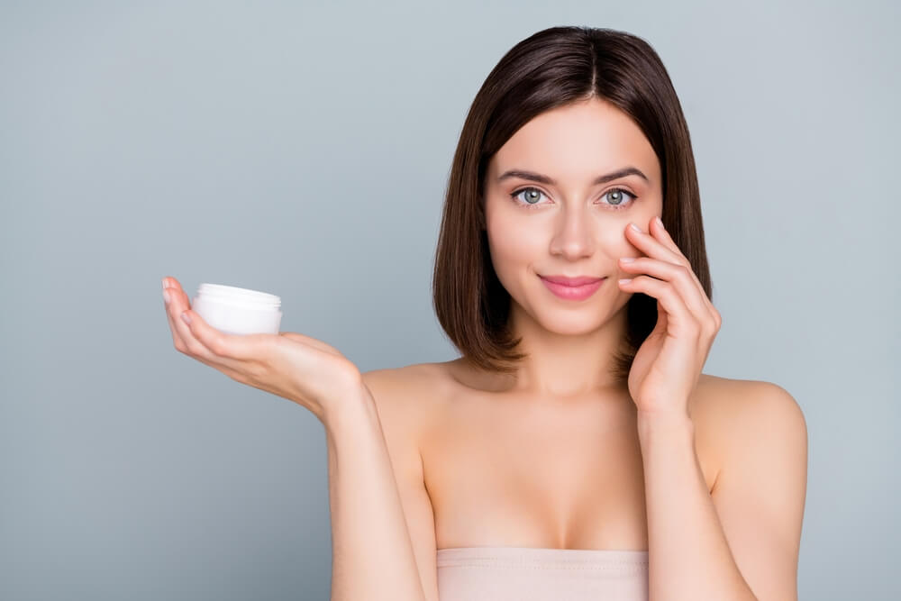 woman holding moisturizer