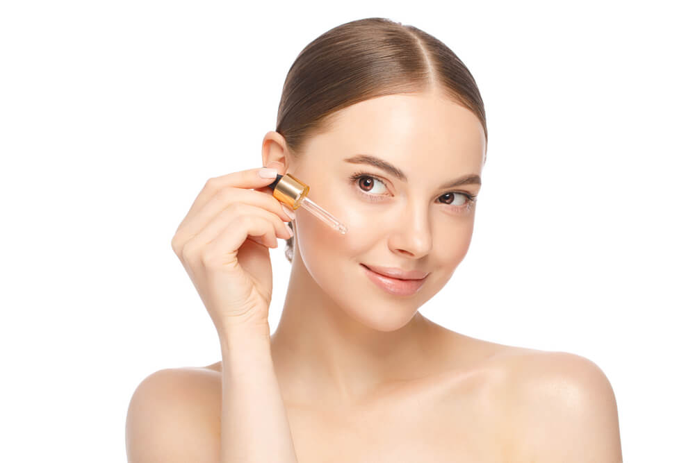 woman applying serum